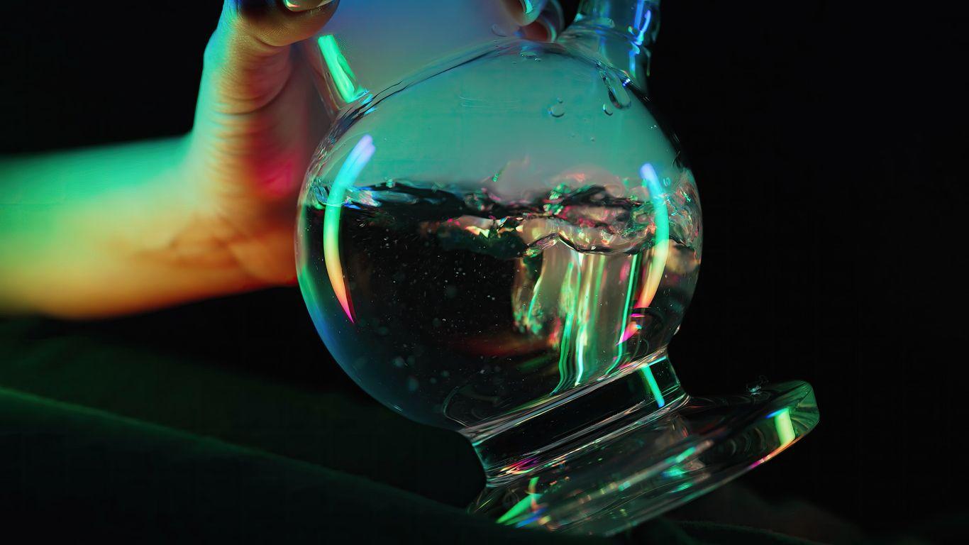 Woman holding a glass bong with water