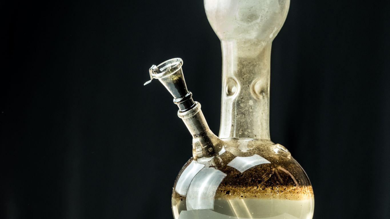 Close-up of a bong with dirty water