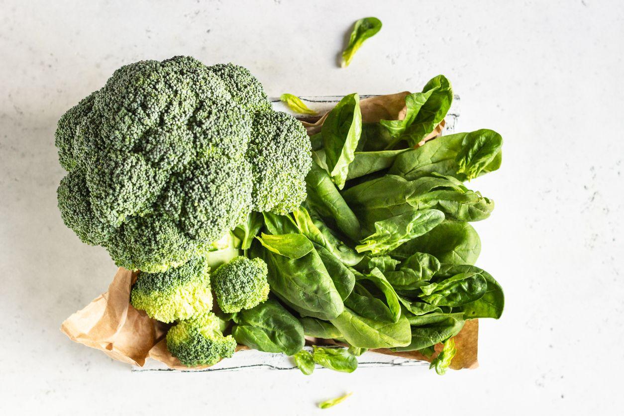 Broccoli and spinach in a wooden tray