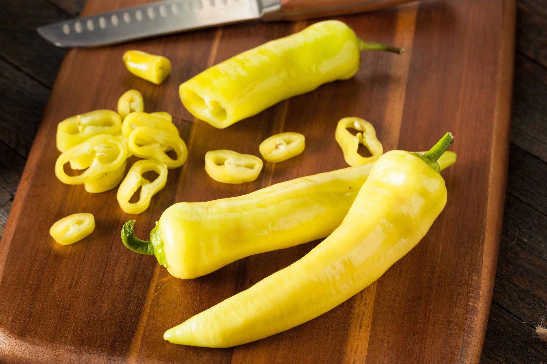 Banana peppers on a cutting board