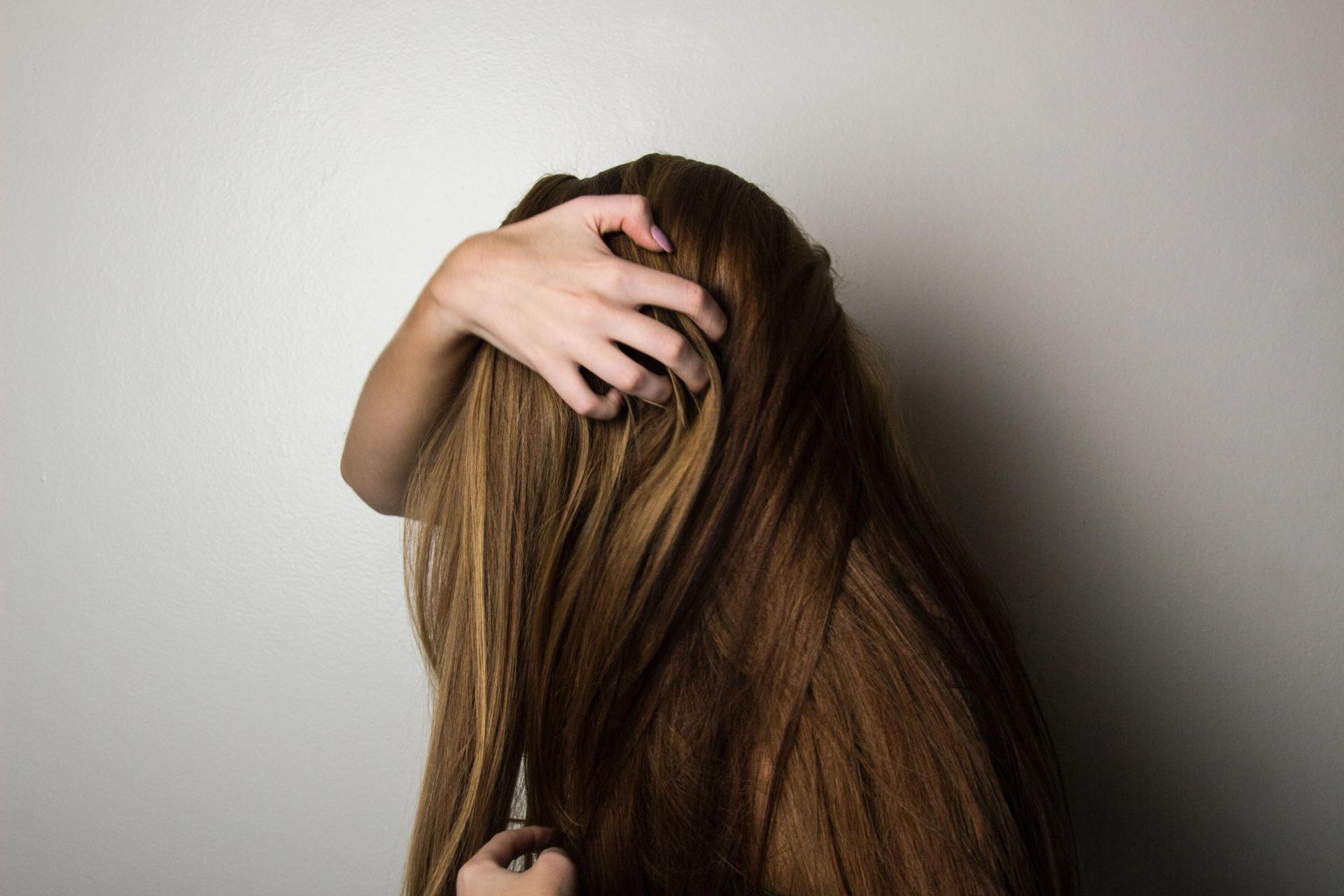 A Girl Touching her Hair