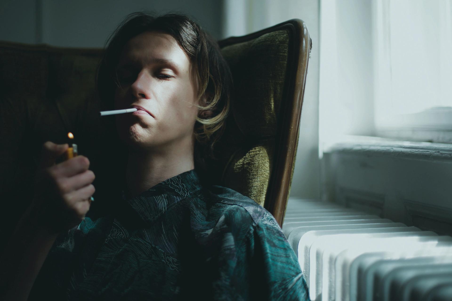 A Man Smoking in his Room