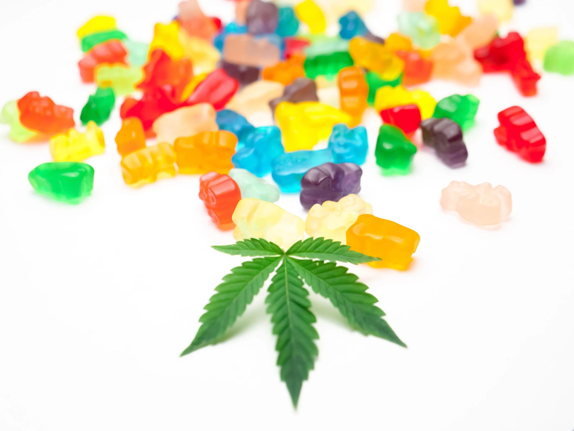 Colorful Gummies next to a Weed Leaf